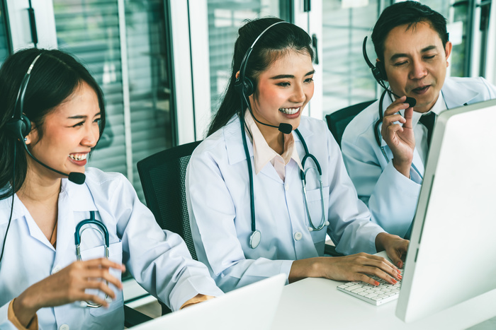 Doctor team wearing headset talking actively on video call in hospital clinic