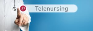 Telenursing. Doctor in smock points with his finger to a search box. The term Telenursing is in focus